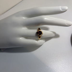 Three stone ring, (two blue sapphire, one garnet), 14K ring