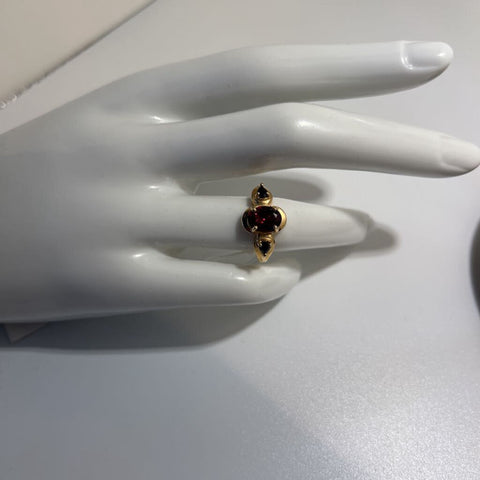 Three stone ring, (two blue sapphire, one garnet), 14K ring