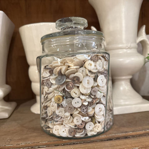 Vintage jar with white buttons