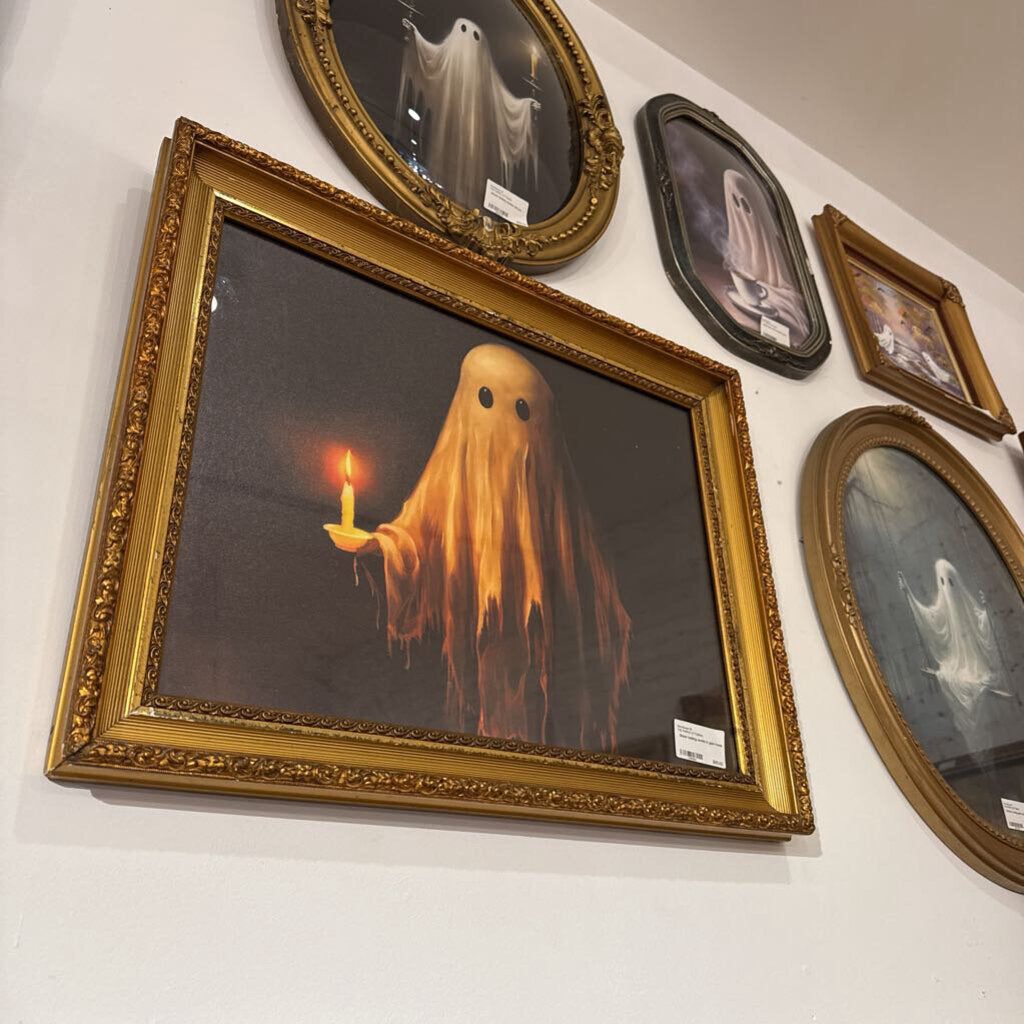 Ghost holding candle in gold frame