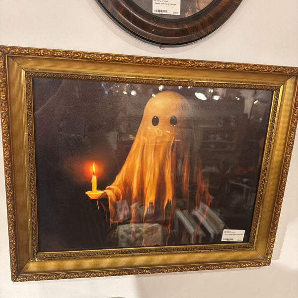 Ghost holding candle in gold frame