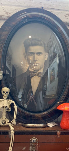 Vintage oval glass framed spooky portrait