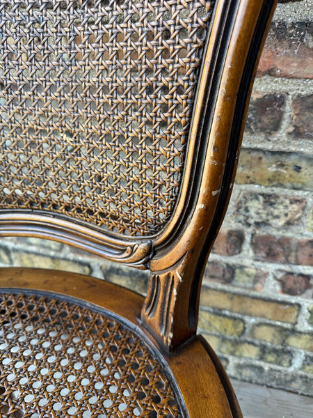 Wooden carved cane chair with bow detail