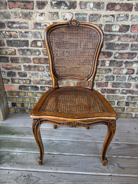 Wooden carved cane chair with bow detail