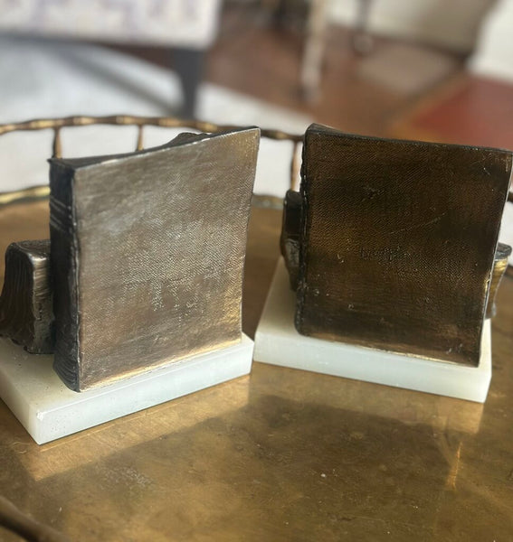 PAIR OF “BOOKISH” BOOKENDS ON MARBLE BASES. EACH BOOKEND IS 6"H x 5"W x 4"H