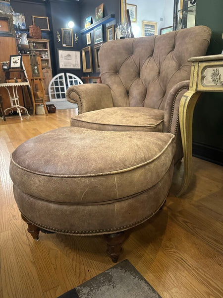 DISTRESSED LEATHER WRITER'S CHAIR AND OTTOMAN, NAILHEAD TRIM. FROM PEABODY’S, MEQUON, WI. 39"H x 37"W x 40"D, OTTOMAN DIM: 26"W x 22"D x 17"H, IN STORE PICKUP