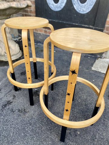 Pair of tan bar stools with stenciled stars
